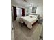 Cozy bedroom featuring tiled floors, ceiling fan, and comfortable furnishings at 3854 Chutney St, Las Vegas, NV 89121