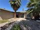 The cozy home features desert landscaping and is shaded by mature palm trees at 3854 Chutney St, Las Vegas, NV 89121