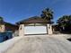 A two car garage with driveway provides parking and storage for vehicles and household items at 3854 Chutney St, Las Vegas, NV 89121