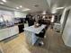 Open kitchen layout with marble island, stainless steel appliances, and natural light at 3854 Chutney St, Las Vegas, NV 89121