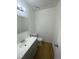 Half bathroom featuring a single sink vanity and toilet with wood look floors at 4363 Spencer St # 8, Las Vegas, NV 89119