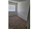 Bedroom with neutral carpet, window with blinds, and white walls at 4363 Spencer St # 8, Las Vegas, NV 89119