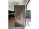 Front entryway showing access to the kitchen with dark cabinets, a laminate floor, and stainless steel appliances at 4363 Spencer St # 8, Las Vegas, NV 89119