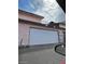 Attached two-car garage featuring a modern door, located in the rear of the townhome at 4363 Spencer St # 8, Las Vegas, NV 89119