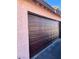 Close-up of a brown paneled garage door, providing secure and stylish access to the home at 4363 Spencer St # 8, Las Vegas, NV 89119