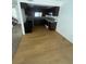 Eat-in kitchen featuring laminate floors, dark cabinets, light countertops, and stainless steel appliances at 4363 Spencer St # 8, Las Vegas, NV 89119
