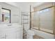 Clean bathroom featuring a shower-tub combination with sliding glass doors and a window at 460 Crestway Rd, Henderson, NV 89015