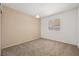 Neutral bedroom with carpeted flooring and a window with vertical blinds at 460 Crestway Rd, Henderson, NV 89015