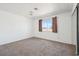 Cozy bedroom with neutral colors, carpet flooring, and a large window, perfect for relaxation at 460 Crestway Rd, Henderson, NV 89015
