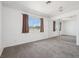 Bright bedroom featuring a window, plush carpeting, and a mirrored sliding-door closet at 460 Crestway Rd, Henderson, NV 89015