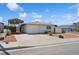 Charming single-story home with a covered parking area and well-maintained front yard at 460 Crestway Rd, Henderson, NV 89015