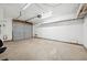A spacious garage with an automatic door, concrete floor, and overhead lighting at 460 Crestway Rd, Henderson, NV 89015