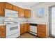 Functional kitchen with wooden cabinets, modern appliances, and a window offering natural light at 460 Crestway Rd, Henderson, NV 89015