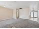 Neutral living room features carpet flooring and a light-filled open layout, creating an inviting atmosphere at 460 Crestway Rd, Henderson, NV 89015