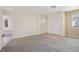 Well-lit living room boasting fresh carpet and a welcoming entryway with decorative double doors at 460 Crestway Rd, Henderson, NV 89015