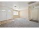 Open-concept living room featuring new carpet, neutral paint, and ample natural light at 460 Crestway Rd, Henderson, NV 89015