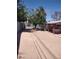 View of the expansive backyard with a covered back porch and large shady trees at 4727 Conrad St, Las Vegas, NV 89121