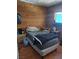 Wood paneled bedroom providing cozy style with furnishings and side table at 4727 Conrad St, Las Vegas, NV 89121