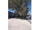 Spacious driveway, covered porch and desert landscaping with mature tree at 4727 Conrad St, Las Vegas, NV 89121