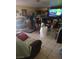 Open concept living room with a television, tile flooring, and a neutral color scheme at 4727 Conrad St, Las Vegas, NV 89121