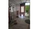 Covered patio area of the home with open windows and doorway, plus pet accessories at 4727 Conrad St, Las Vegas, NV 89121