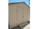 Close-up view of a tan-colored backyard storage shed at 4727 Conrad St, Las Vegas, NV 89121
