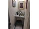 Small vanity area with mirror and accessories, illuminated by overhead lighting and decorated with fun artwork at 4727 Conrad St, Las Vegas, NV 89121