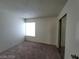 Bedroom featuring carpeted floor, a bright window, and a mirrored closet at 4795 Via San Andros, Las Vegas, NV 89103