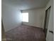 This bedroom has carpet flooring and a window at 4795 Via San Andros, Las Vegas, NV 89103