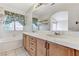 Bathroom featuring double sinks, vanity, and window with natural light at 5016 Jacarilla Ln, North Las Vegas, NV 89031