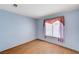 Empty bedroom with laminate flooring and a window with blinds at 5016 Jacarilla Ln, North Las Vegas, NV 89031