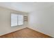 Neutral bedroom with laminate floors, window, and built-in shelves at 5016 Jacarilla Ln, North Las Vegas, NV 89031
