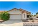 Inviting single-story home with a two-car garage and low-maintenance desert landscaping at 5016 Jacarilla Ln, North Las Vegas, NV 89031