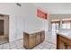 Open-concept kitchen with tile floors and a center island, flowing into the living area at 5016 Jacarilla Ln, North Las Vegas, NV 89031