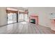 Bright living room with a fireplace, tile flooring, and sliding glass door leading to the backyard at 5016 Jacarilla Ln, North Las Vegas, NV 89031