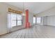 Open concept living room features tile flooring, large windows, and abundant natural light at 5016 Jacarilla Ln, North Las Vegas, NV 89031