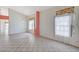 Bright, spacious living room with tile flooring and large windows with unique patterned curtains at 5016 Jacarilla Ln, North Las Vegas, NV 89031