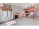 Open floor plan with tile flooring, a fireplace, and a view into the kitchen area at 5016 Jacarilla Ln, North Las Vegas, NV 89031