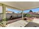 View of backyard patio area with concrete and gravel and patio cover at 5016 Jacarilla Ln, North Las Vegas, NV 89031
