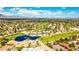 Expansive aerial view of a lush golf course community with homes, water features, and desert mountain backdrop at 5041 Portraits Pl, Las Vegas, NV 89149