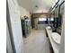 Open bathroom with double sinks, decorative cabinet, and marble flooring at 5041 Portraits Pl, Las Vegas, NV 89149