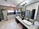 Upscale primary bathroom with dual sinks, decorative mirrors, and lots of counter space at 5041 Portraits Pl, Las Vegas, NV 89149