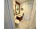 Compact half bath with white marble flooring and an elegant mirror and sink at 5041 Portraits Pl, Las Vegas, NV 89149