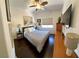 Comfortable bedroom with neutral walls, a ceiling fan, and a dresser with mounted television at 5041 Portraits Pl, Las Vegas, NV 89149