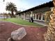 Stylish clubhouse exterior with manicured lawn and patio area, ideal for relaxation and entertainment at 5041 Portraits Pl, Las Vegas, NV 89149
