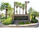 Portraits community sign adorned with palm trees and colorful landscaping, creating an inviting entrance at 5041 Portraits Pl, Las Vegas, NV 89149