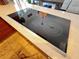 Close up of a modern, glass cooktop featuring sleek design elements and integrated controls at 5041 Portraits Pl, Las Vegas, NV 89149