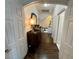 Inviting hallway with dark wood floors, white trim, and staircase access at 5041 Portraits Pl, Las Vegas, NV 89149