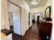 Well-lit hallway with hardwood floors leading to various rooms with unique decorations at 5041 Portraits Pl, Las Vegas, NV 89149