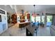The updated kitchen features wood cabinets, stainless appliances, and a breakfast bar that connects to the living and dining areas at 5041 Portraits Pl, Las Vegas, NV 89149